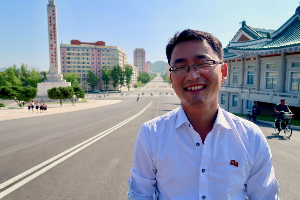 A male KITC guide smiles for the camera in Pyongyang.