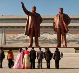 A group of Koreans regard the monuments of Kim Il Sung and Kim Jong Il at Mansudae Grand Monument.