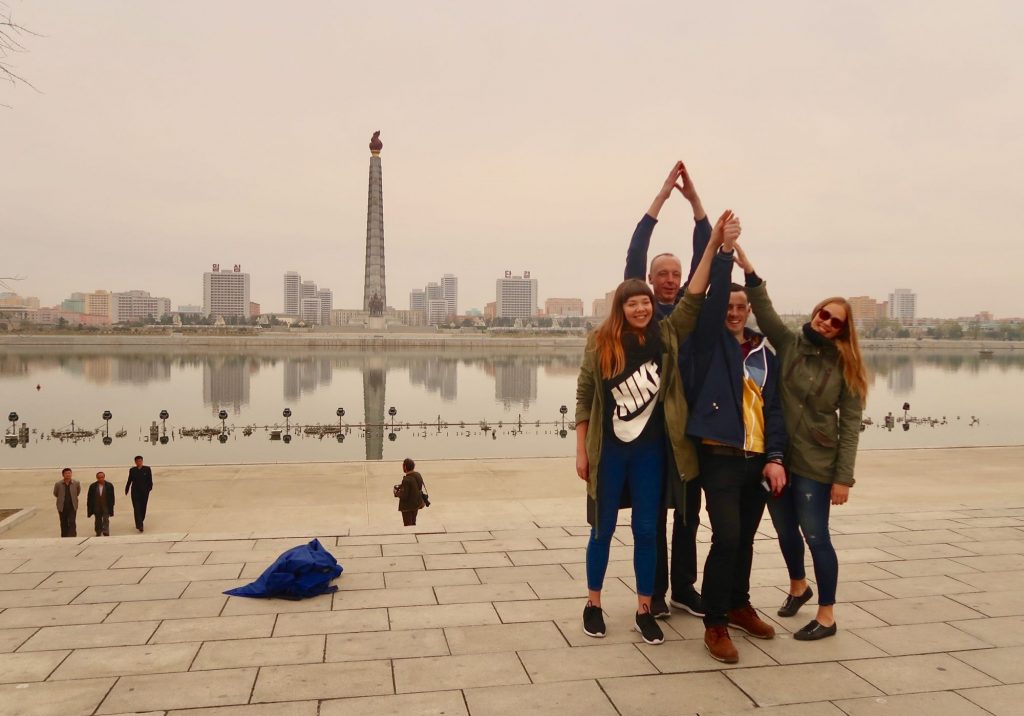 Our group takes a photo with the Juche Tower in the background