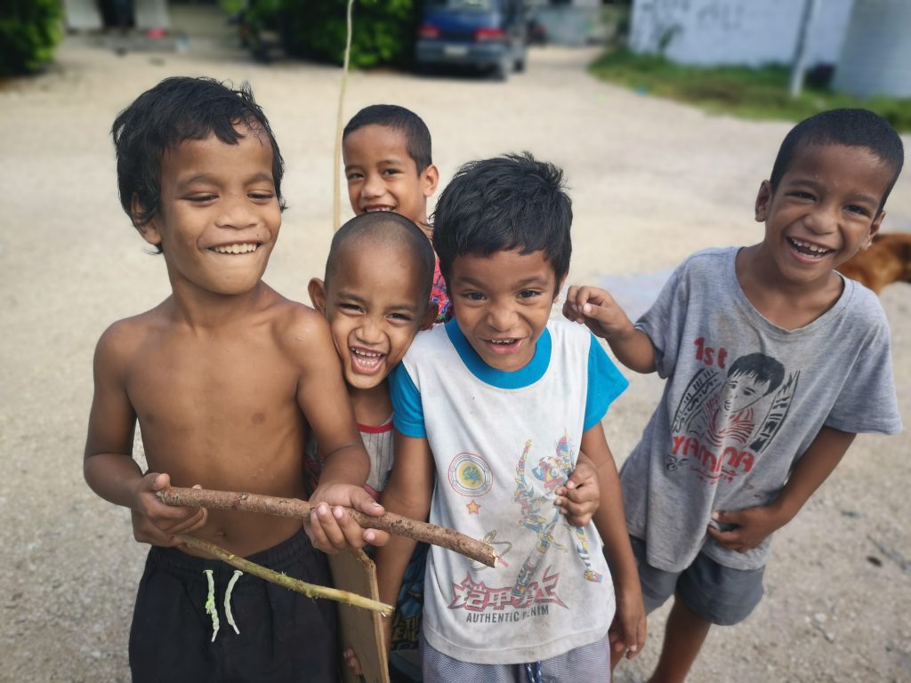 Some laughing kids in Nauru as part of a Mega Tour of the Least Visited Countries in the world
