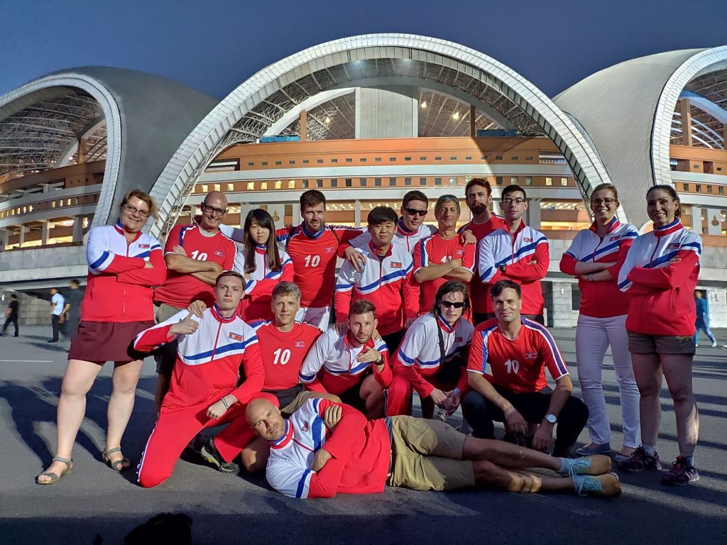 Our group wearing North Korean tracksuit in front of the May Day Stadium