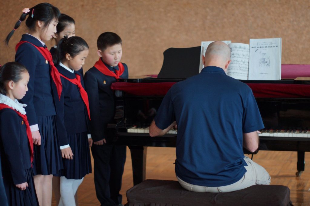 A guest playing piano to North Korean Children at the Mangyongdae School Children's Palace