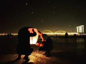Lighting lanterns along the river