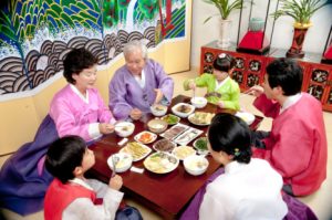 A Korean family enjoying a meal during Korean New Year. 