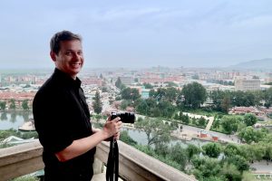 Making a North Korea documentary: Justin Martell overlooking a North Korean city. 