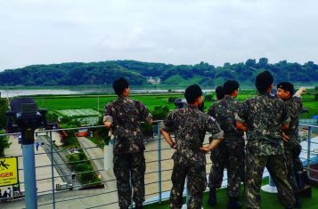 South koreans looking over to north korea