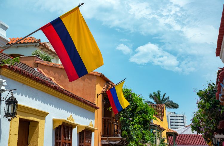 Low Angle View Of Colombian Flags On Houses In City