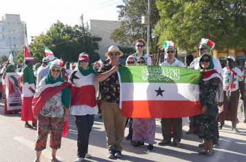 YPT holding the flag of Somaliland during the military parade
