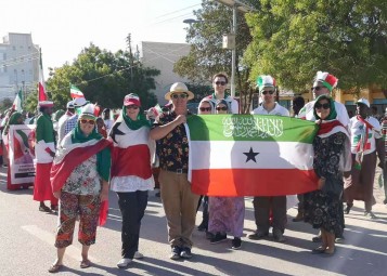 YPT holding the flag of Somaliland during the military parade
