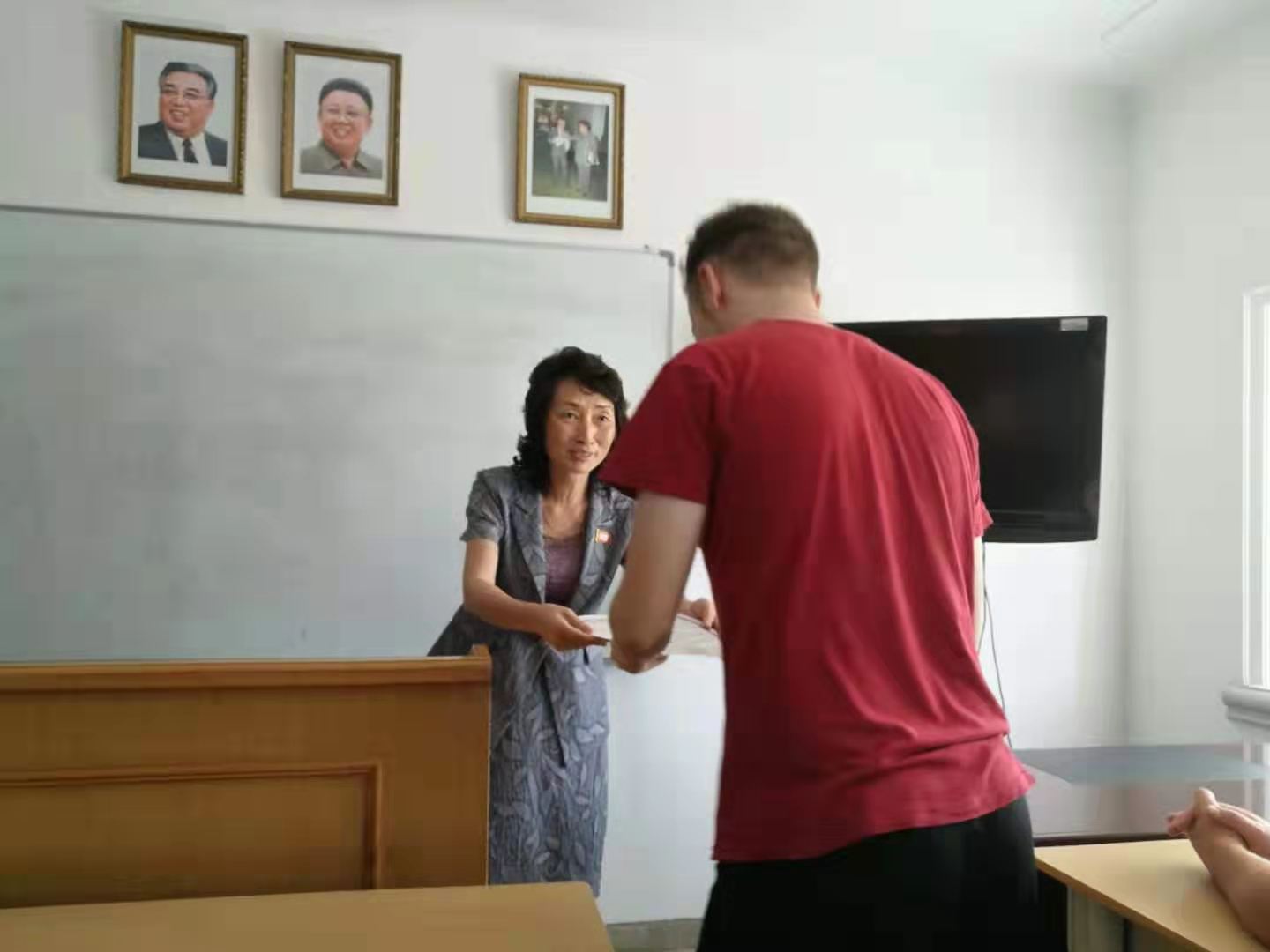A student receiving his certificate on his Pyongyang Korean Language Study Tour