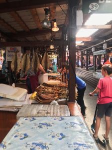 Shoppers examine fish at Listvyanka fish market.