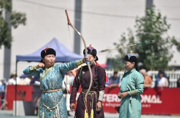 Mongolian archery: an archer looses an arrow at the Ulaanbaatar naadam.