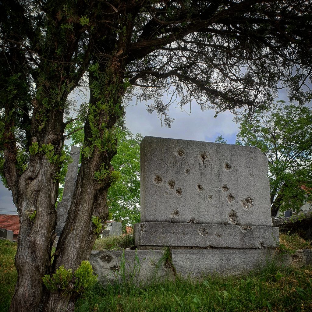 Dark history locations of the Balkans: a bullet-riddled gravestone outside Belgrade. 