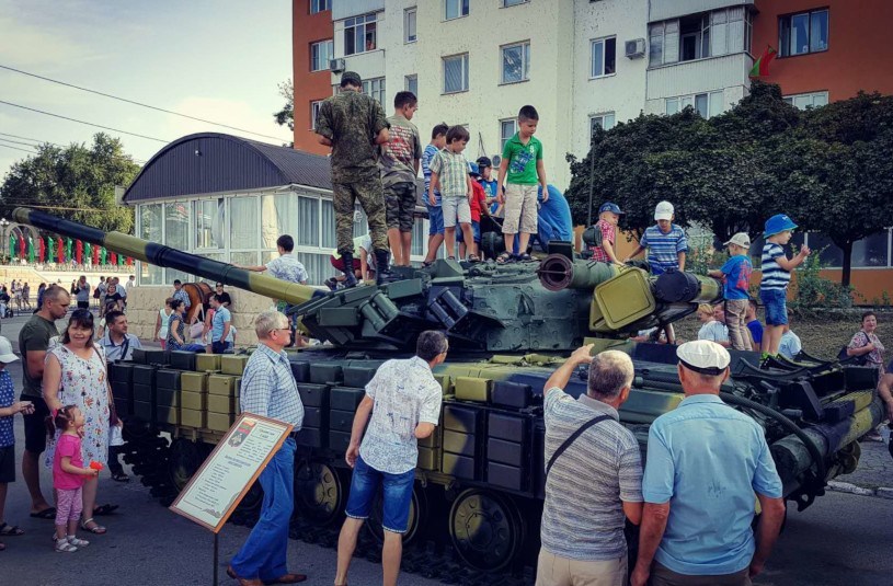 Festivals in Transnistria: children clamber on a tank as adults look on during Independence Day festivities in Tiraspol, Transnistria.