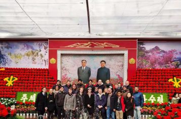 Our group standing in front of a mural of the leaders of the DPRK