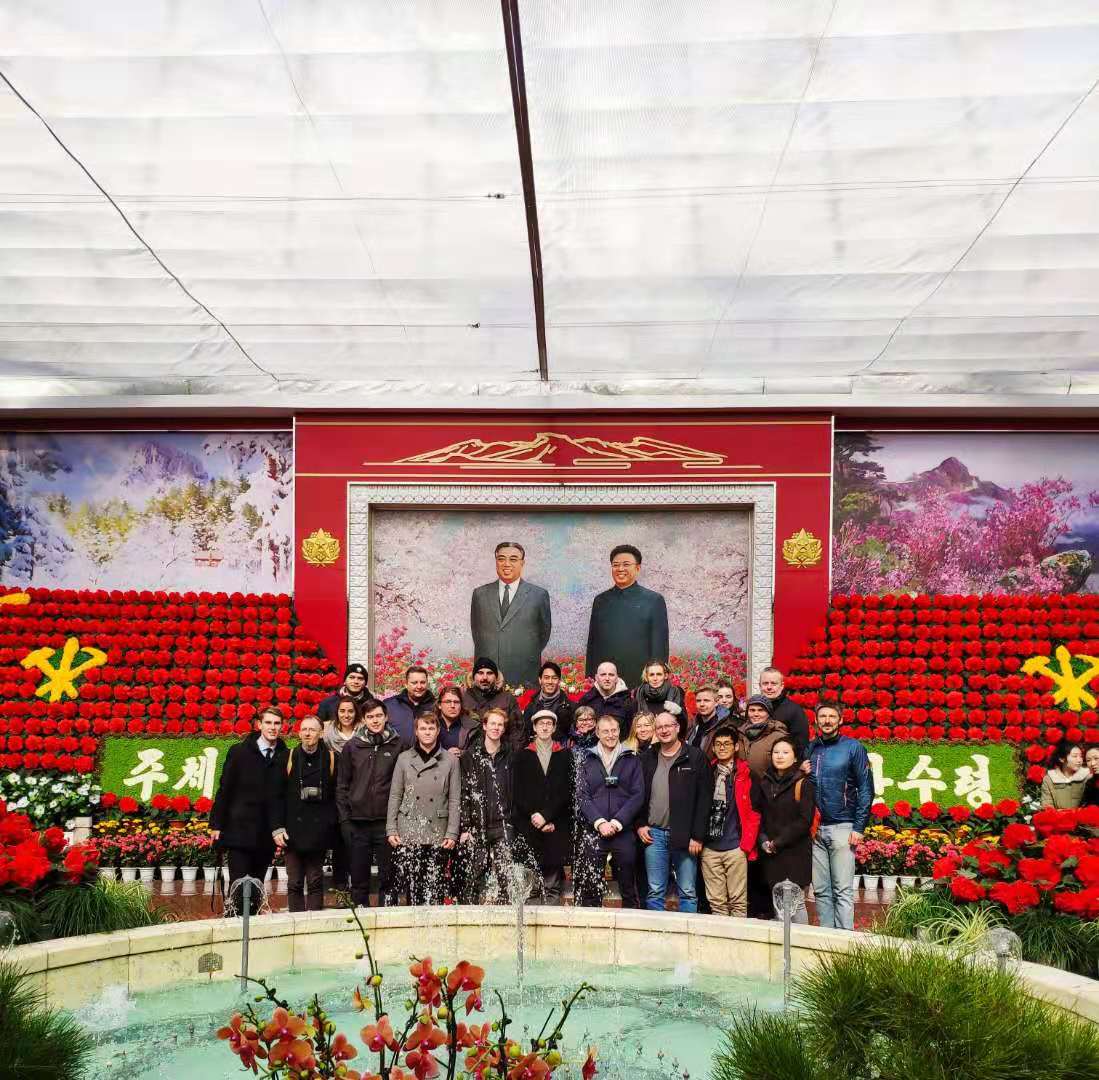 Our group standing in front of a mural of the leaders of the DPRK