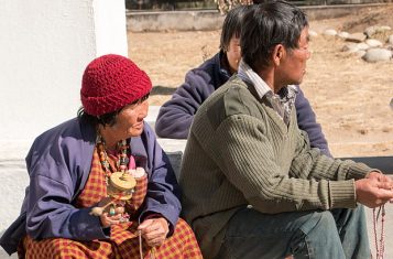 People holding prayer wheels in Bhutan