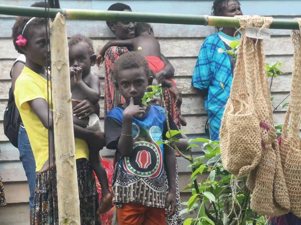 A kid wearing a shirt with the flag of Bougainville, a common sight throughout the island.