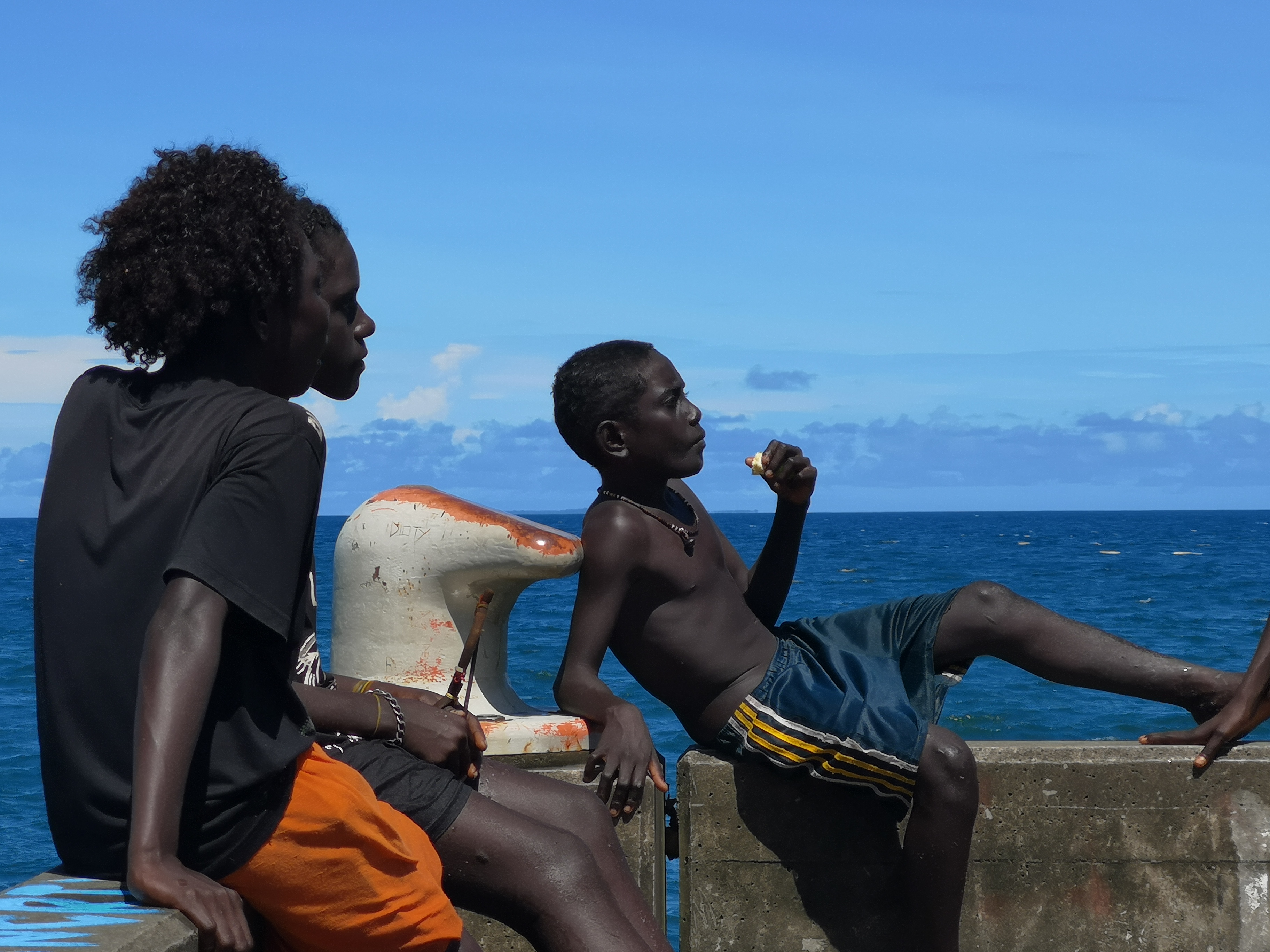 Youngsters are relaxing on the beach, a few kilometres away from the Solomon Islands