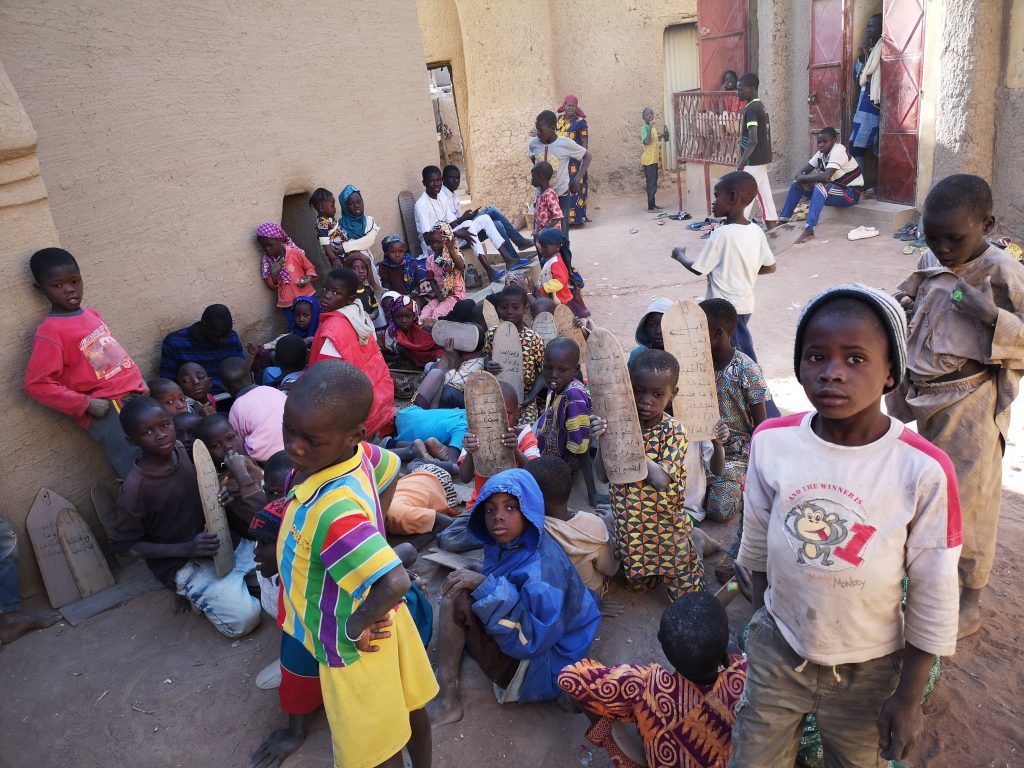 kids studying outside at a local madrassa in Djenné, Mali