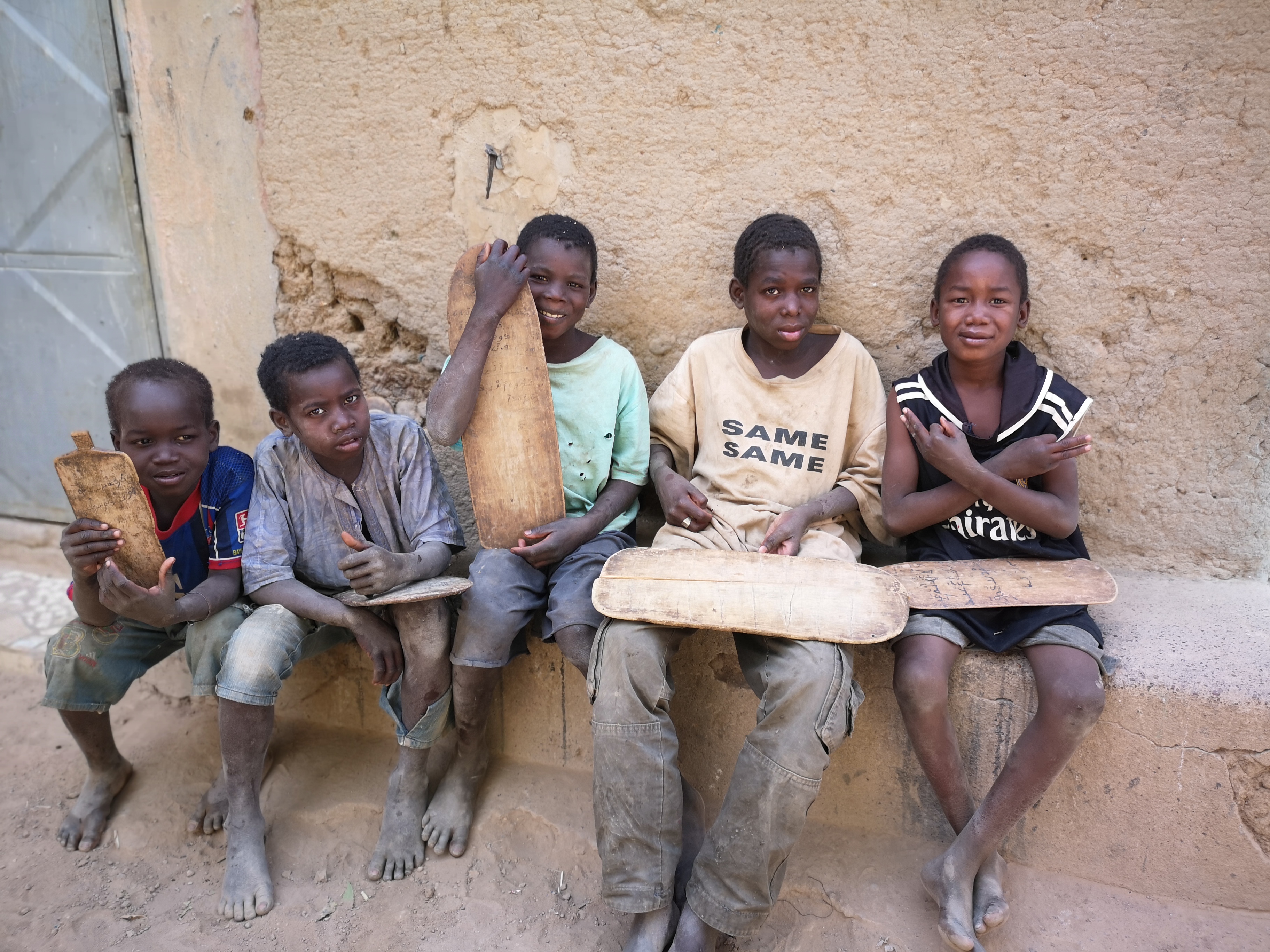 kids studying outside at a local madrassa in Djenné, Mali