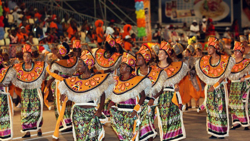 Angola Carnival dancers make their way through the streets in colourful costumes.