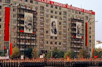 A photograph of Marx, Engels and Lenin adorning an old DDR housing block.