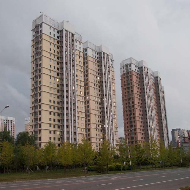 New Yalu River Bridge apartments stand almost empty, only a handful of lights visible in the windows. 