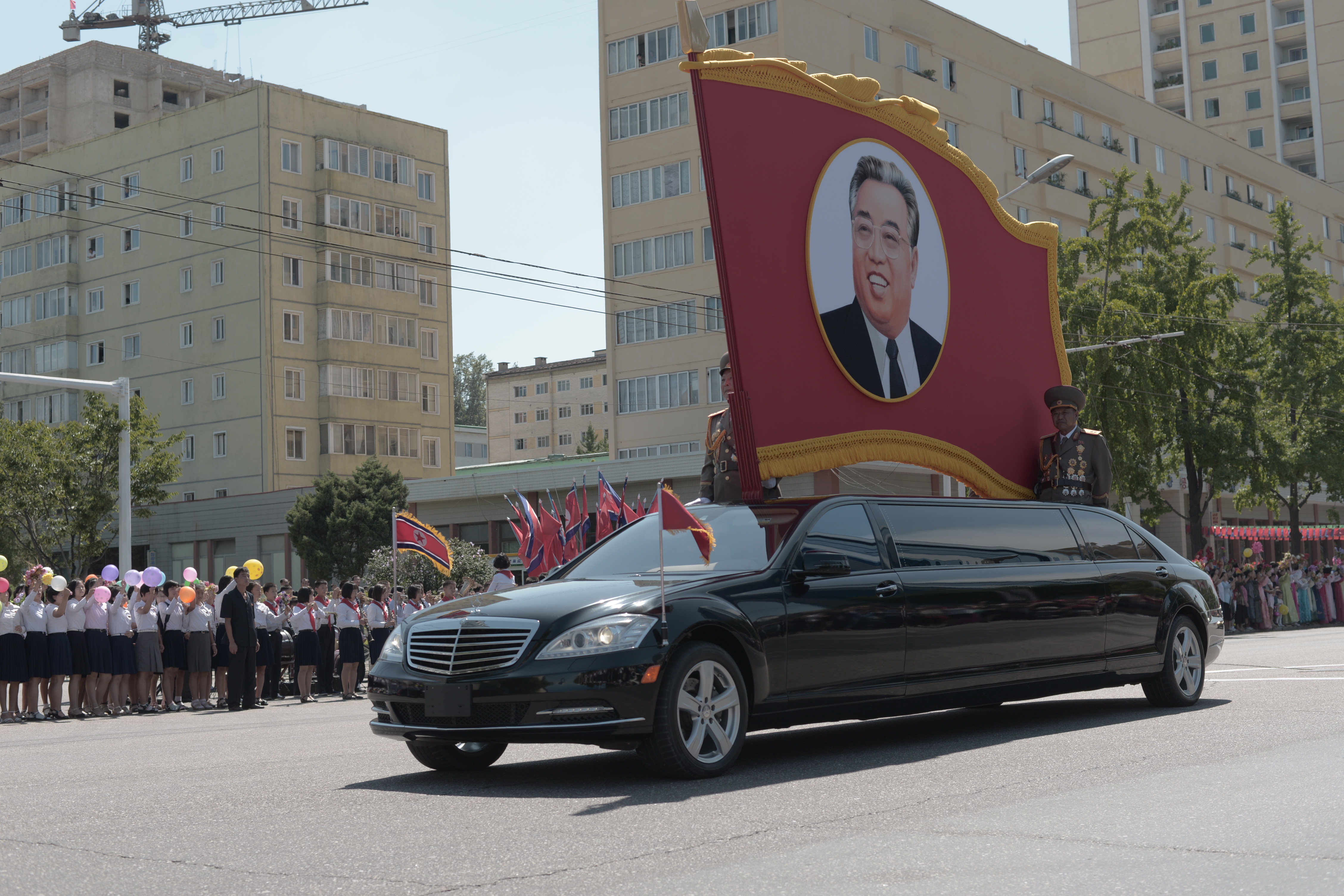 Limousine carrying a portrait of Kim Il-Sung, Eternal president of the DPRK