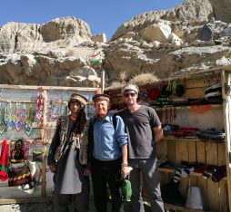 Pamir Highway: YPT guide Troy poses with a Tajik hat vendor along the Pamir Highway.