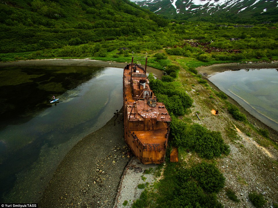 The rusting hulk of a ship sits grounded at Kamchatka. 
