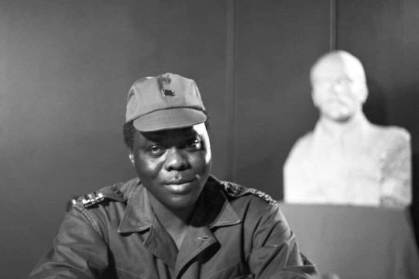 The young Mathieu Kerekou, standing in front of a bust of Lenin