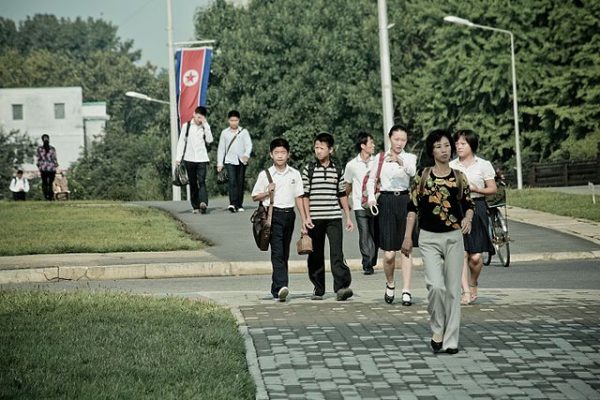North Koreans of different heights walking in the streets