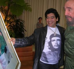 Diego Maradona presenting a painting to Fidel Castro