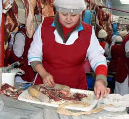 A woman prepares horse meat in Kazakhstan, taken by