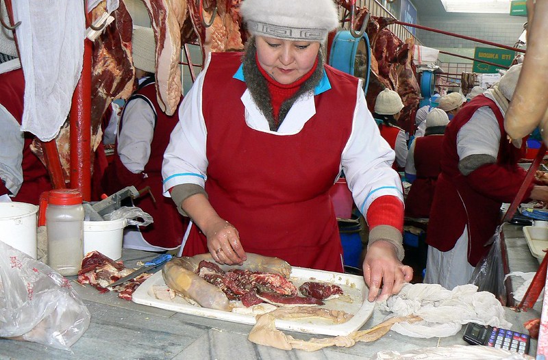 A woman prepares horse meat in Kazakhstan, taken by